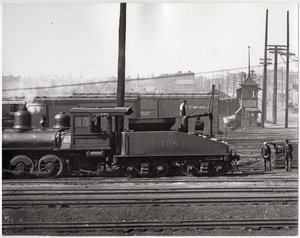 Stoomlocomotief en treinwagons op een onbekend rangeerterrein
